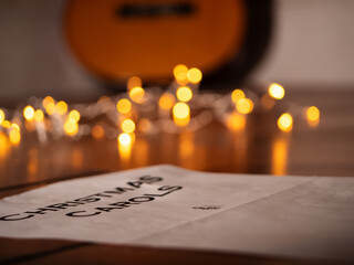 Acoustic guitar in front of Christmas lights 
