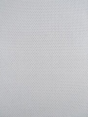 Close-up view of a canvas texture with visible fibers and subtle grain, design, canvas