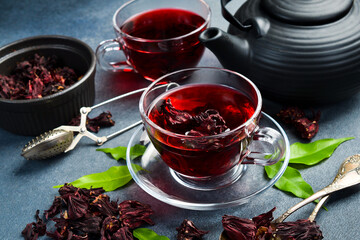 Close-up of a cup of tea. Red hibiscus tea with flowers. © Yaruniv-Studio
