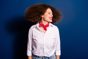 Photo of adorable carefree girl wear red tied handkerchief dancing empty space isolated blue color background