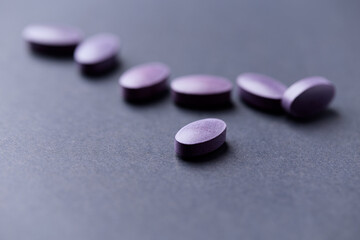 Lutein tablets. Dietary supplement on paper background. Soft focus. Close up. Copy space	