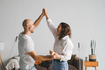 A joyful dance between a blind couple in their cozy living room