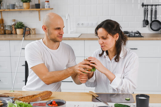 Blind couple preparing and enjoying a homemade sandwich together