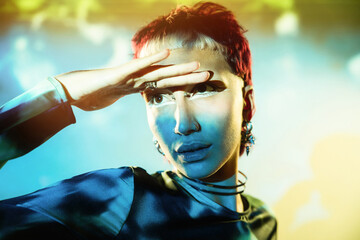 Futuristic woman with blue face paint in a surreal setting