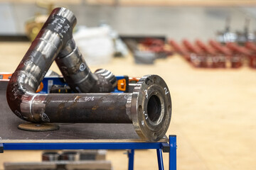Pipe with many bends after welding. Fragment of pipeline with white inscriptions. Pipe with turns...