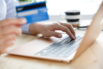 Fototapeta premium Woman shopping online using laptop computer and credit card
