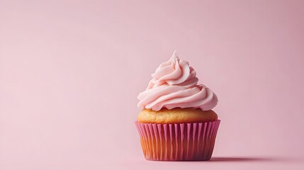 Cupcake with pink cream, isolated in a pink background with copy space