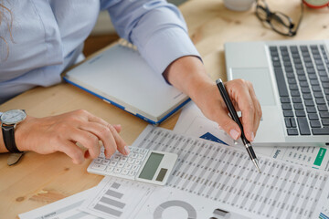 Businesswoman financial planning and making accounting database report at workplace