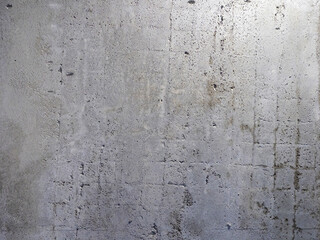 Gray concrete wall. Surface of fence with traces of grating. Concrete wall background. Gray texture. Construction backdrop. Wall with chips. Smooth fence pattern. Concrete surface.