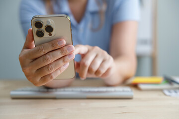 Freelancer woman works at home and using smartphone