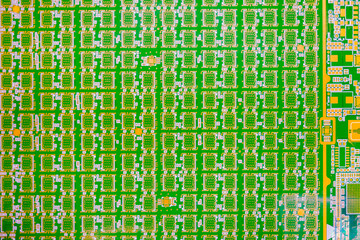 Close-up fragment digital board. Green computer microboard. Microelectronics under magnifying glass. Macro shot of digital board with yellow and white traces. Digital board for computer. PCB backdrop