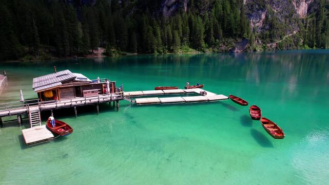 One of the most beautiful mountain Alpine lakes - magic Lago di Braies, sorrounded by Dolomites mountains. south Tyrol, Italy. aerial drone 4k hd video