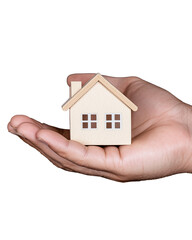 Wooden house model held in hand on transparent background