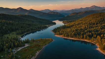 Obraz premium Aerial view of winding lake surrounded by mountains at sunset.