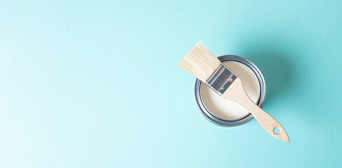Paint can with white chalk color and a paintbrush, painting old furniture, renovating at home,...