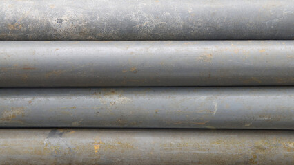 stack of old dirty gray pvc pipes horizontally background texture with worn surface, abstract taken from above with soft focus