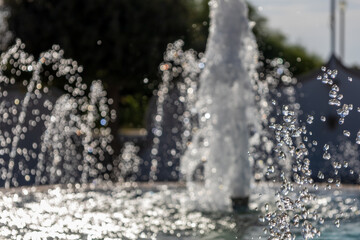 Water drops splashing from a fountain in a park