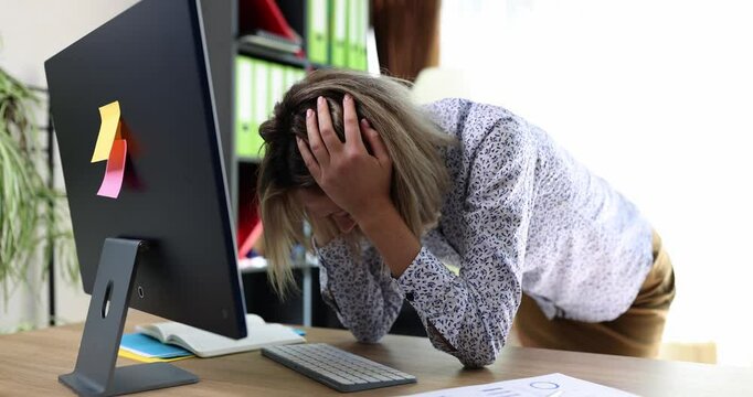 Frustrated female manager shouts looking at computer monitor and covering head with hands. Company employee discovered error in tax report