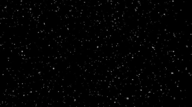 Snowflakes falling on a black background. 4K slow motion video animation