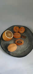 fresh yellow lemon and apricots on the grey plate