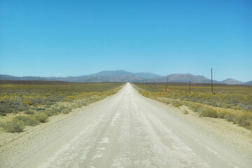 Outdoor, nature and path with highway for adventure, destination and location for holiday journey. Dirt road, environment and blue sky to explore with mountains, landscape and travel in Switzerland