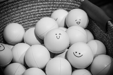 a lot of rubber balls with smiley faces