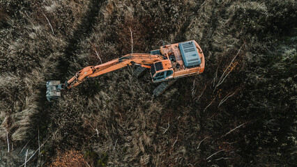 Orange excavator standing on the mine, orange excavator in the sand desert, orange excavator...