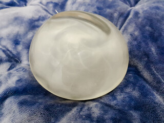 Silicone breast augmentation surgery, smooth silicone breast implants placed on sofa, medical...