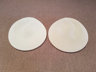 Silicone breast augmentation surgery, rough silicone breast implants placed together, brown...
