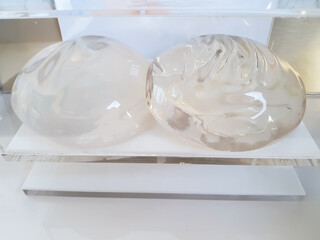 Silicone breast implants surgery. Smooth silicone breast augmentation are placed on medical...