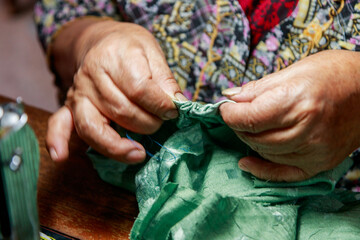 Dedicated senior sewing in warm light