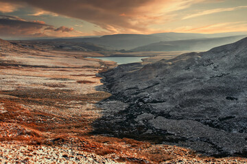 Winter snow scene of the pennine hills on the Yorkshire moorlands in England. With distant lake set in a valley covered by frost and snow. Cold and fresh.