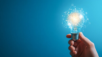 Hand holding a lit light bulb representing innovation and new ideas