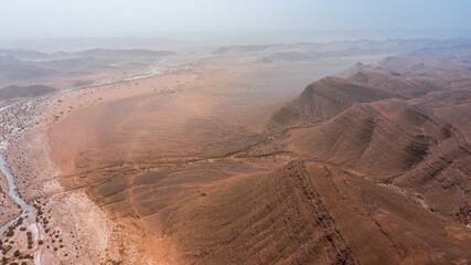 Moroccan Sahara Desert, ancient black volcanic mountains, the Sahara River Oued Ghris, stunning...