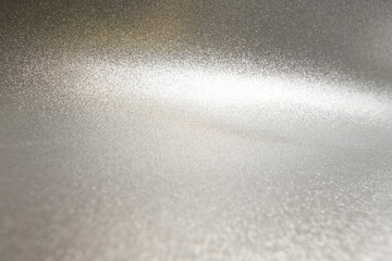 Shiny Silver Glitter Texture with Light Gradient. A sparkling silver glitter texture featuring a...