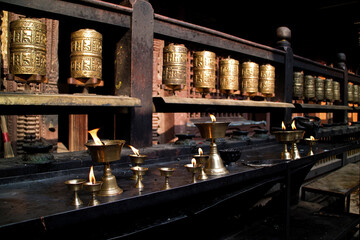 Prayer wheels and butter lamps in a monastry in Kathmandu, Nepal