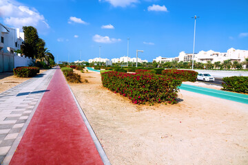 Obraz premium Abu Dhabi, Arab Emirates, Sidewalk, bike path, car track. All types of urban ground transportation are provided - pedestrian, cyclist, driver