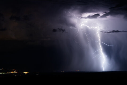 Thunderstorm lightning strike with illuminated rain