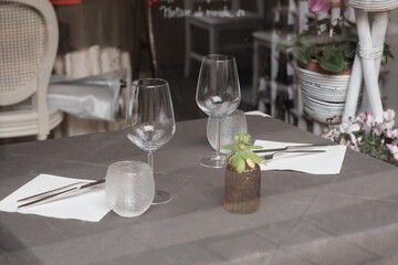 restaurant table set for an elegant dinner on the Ligurian sea in the summer of 2024