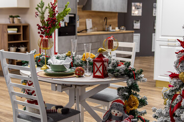 Christmas decoration of a furniture and kitchen store. Festive table setting. Christmas decorations for sale and dishes