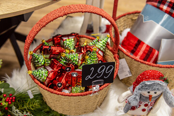 Christmas tree toys in basket in store. Red cars with a Christmas tree. Price tag