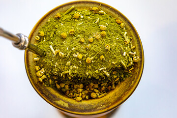 Traditional Brazilian chimarrão served in a gourd with chamomile flowers