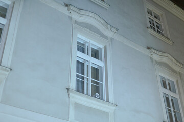 The stunning building facade showcases a multitude of windows and intricate decorative elements that are beautifully illuminated at night, creating an enchanting visual experience