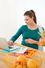 Pregnant woman, laptop and browsing with research for telehealth, information or expecting at home. Female person, stomach and belly with computer for online search, maternity or pregnancy at house