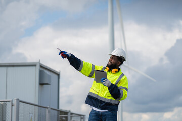 Service engineers checking system of windmill. Wind turbines generate electricity. Clean and Renewable energy concept.