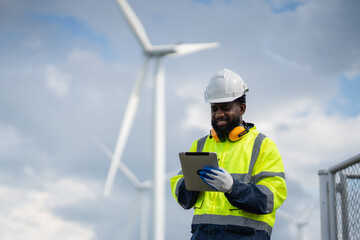 Service engineers checking system of windmill. Wind turbines generate electricity. Clean and Renewable energy concept.