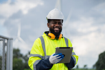 Service engineers checking system of windmill. Wind turbines generate electricity. Clean and Renewable energy concept. © NewSaetiew