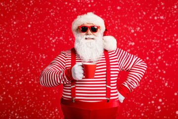 Portrait of his he nice attractive handsome cheerful cheery Santa drinking cacao latte holly jolly...