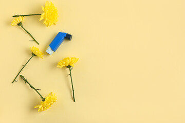 Modern inhaler and chrysanthemum flowers on yellow background
