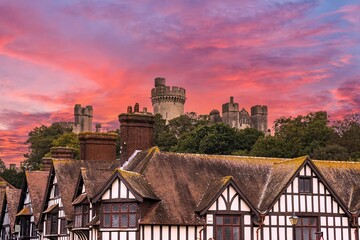 Arundel Castle was established in the 11th century. The castle was damaged in the English Civil War and then restored in the 18th and early 19th centuries.  Sunset sky.